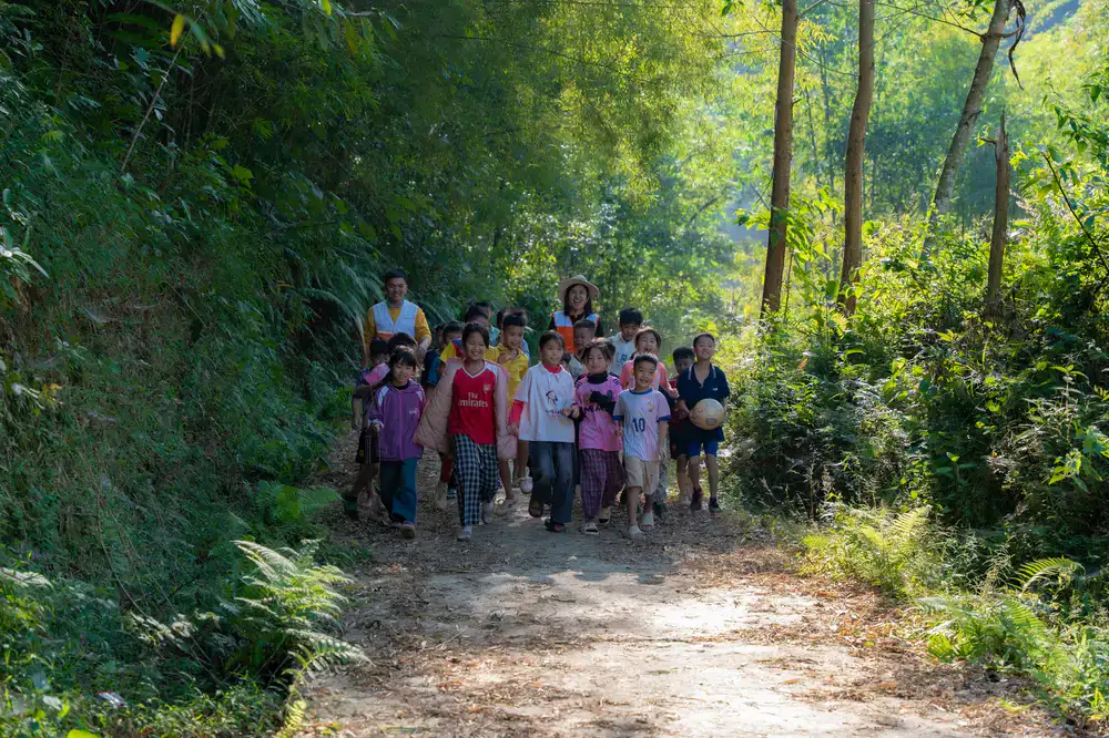 Colleagues gathering wild herbs together during a guided walk